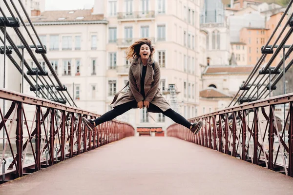 Una Chica Abrigo Con Pelo Suelto Salta Emocionalmente Puente Ciudad — Foto de Stock