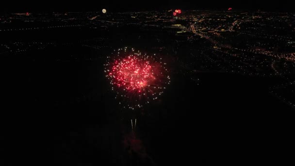 View of fireworks and fireworks from a birds-eye view over the city of Minsk. Colored lights in the sky over a river in Europe. Celebratory salute. Victory day may 9 — Stock Video