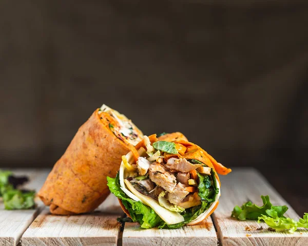 Chicken and cheese tomato tortilla wrap with linen backdrop