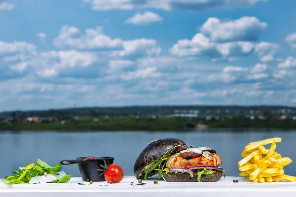 Suyun önünde yakın plan bir hamburger.