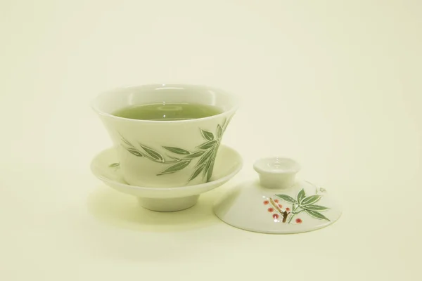 Japanese tea. Matcha tea. Green tea in a beautiful traditional oriental cup with saucer. Isolated in a white bowl on a white background.