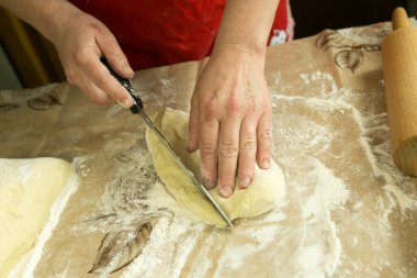 Annemin turtaları. Annem fırın hamuruyla çalışıyor. Annenin elleri. Karantina sırasında yemek pişirme.