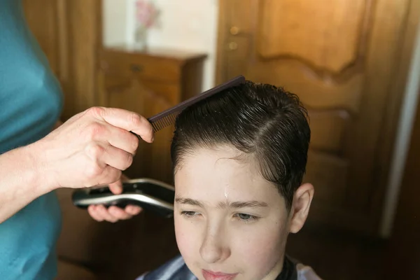 Home haircut during quarantine. The best master is mother\'s hands, scissors and a trimmer.