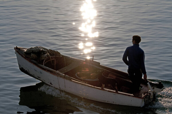 Fisherman and his son in their boat in the harbor of Rab Croatia