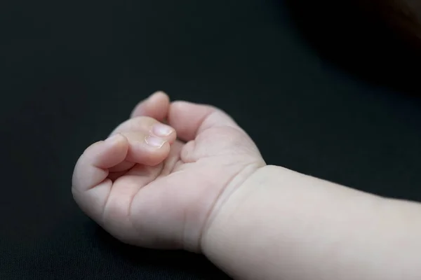 Mão do bebê em preto — Fotografia de Stock