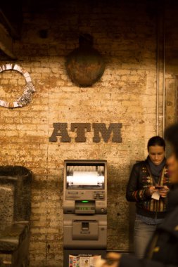 New York City'deki Chelsae Market yanındaki atm makinesi cep telefonu kullanan kadın