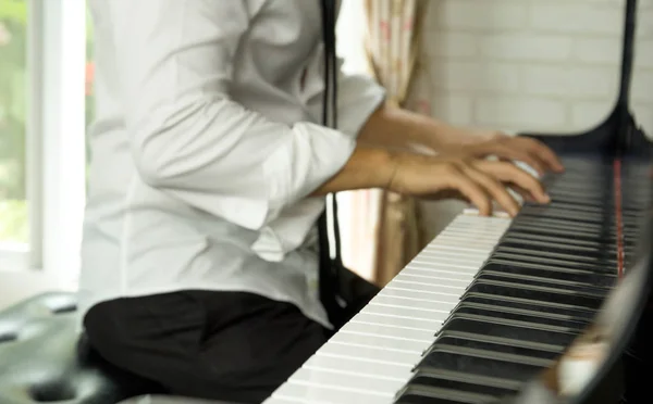 Selected focus on piano keys man playing the piano Royalty Free Stock Images