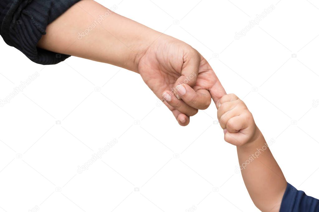 Little child holding her mother's finger while walking outside i