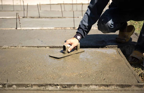 Trabalhador mão usando espátula de aço fazendo piso de concreto — Fotografia de Stock
