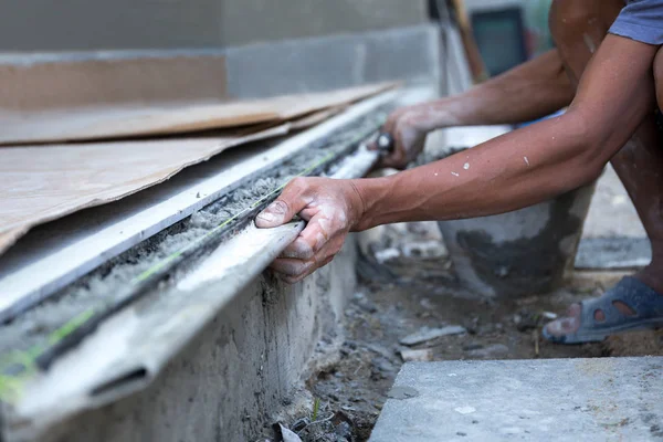 Homem forma a borda do chão com cimento de concreto de gesso — Fotografia de Stock