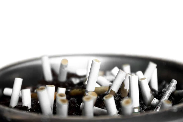 Ashtray closeup full of smoked cigarettes stub isolated — Stock Photo, Image