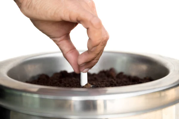 Selected focus cigarette stub hand stubbing out a cigarette in a — Stock Photo, Image