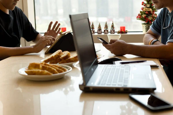 Business colleagues meeting with food ,tablet and laptop on the