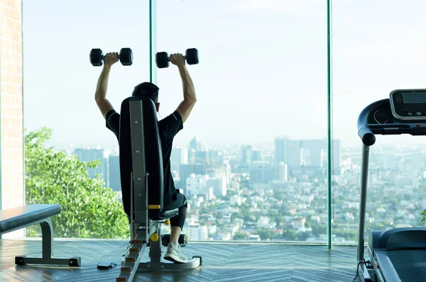 Adam iş dışarı jimnastik salonunda dumbbells ile 