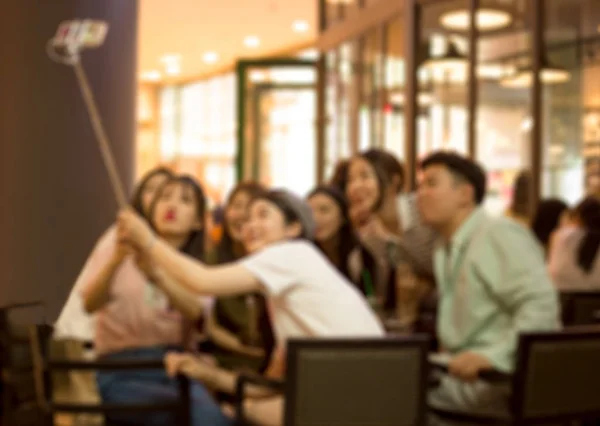 Blurred concept group of Chinese people taking selfie picture