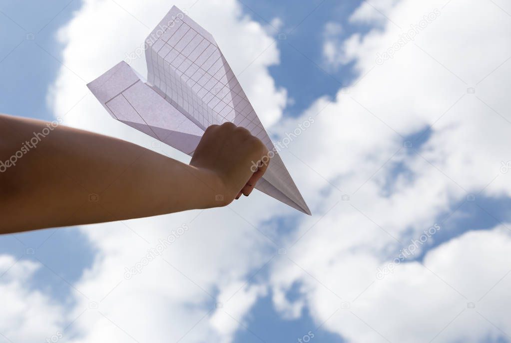 Imagination of woman hand throwing paper plane 