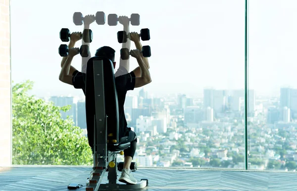 Conceptual Man work out with dumbbells at the gym
