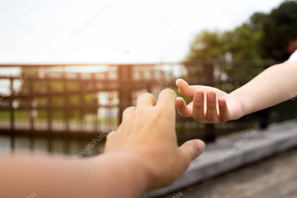 Man and woman hand reaching to each other 