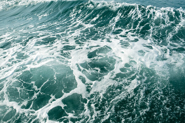 Глубоко зеленая океанская волна с горой и небом
  