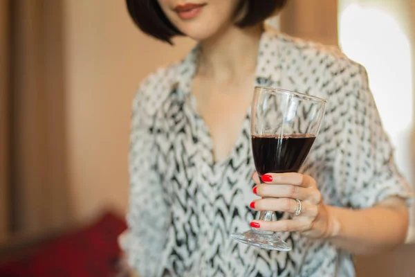 Kobieta z pięknym czerwonym manicure trzymając kieliszek czerwonego wina. Walentynki paznokci sztuka design. — Zdjęcie stockowe