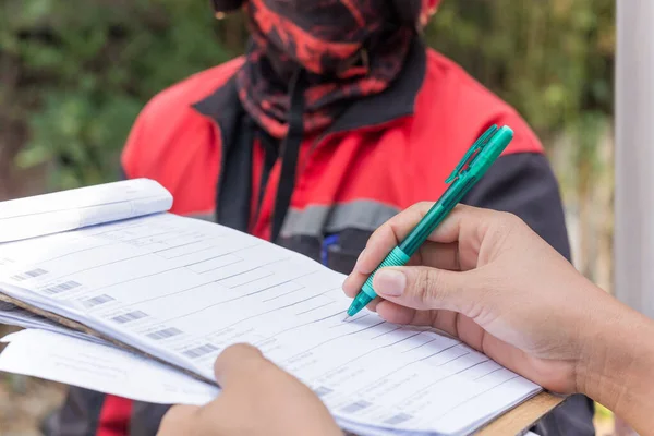 Delivery service female hands holding pen signing delivery document