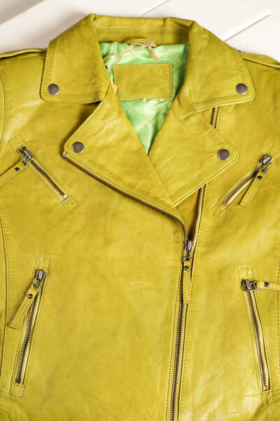 Green color leather jacket. Leather jacket macro details. Jacket zippers and pockets. Lime color leather jacket
