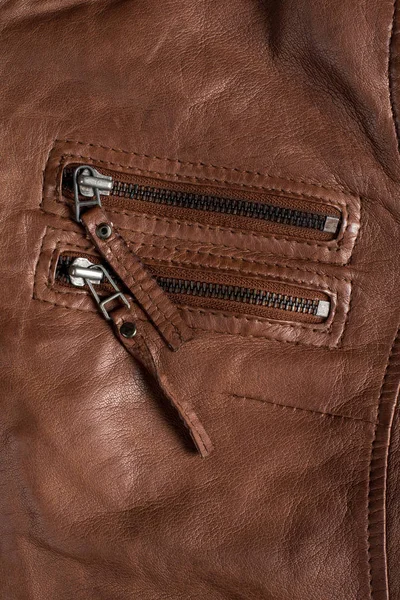 Chaqueta de cuero con textura marrón. Chaqueta de cuero macro detalles. Chaqueta cremalleras y bolsillos . — Foto de Stock