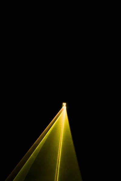 Laser beam yellow on a black background — Stock Photo, Image