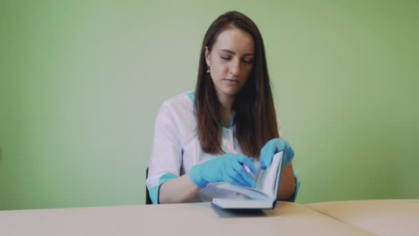 Doctor Writing Something Her Notebook While Spending Time Indoors Her — Stock Video