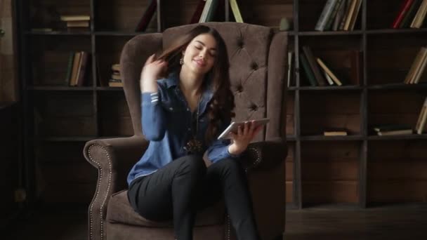 Young Attractive Woman Sitting Posh Armchair Tablet Her Hands Library — Stock Video