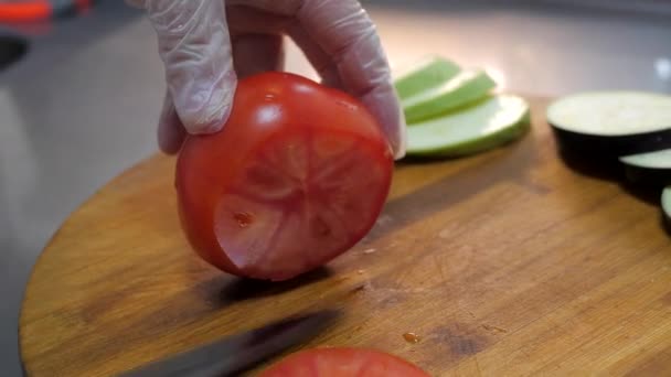 Chef Cuts Red Tomato Thin Slices Wooden Table Close Gloved — Stock Video