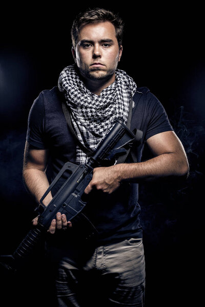 Soldier or mercenary with an assualt rifle or a prop such as paintball or airsoft gun