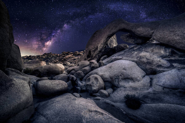 Astro Photographer in a Desert Landscape with view of Milky Way Galaxy