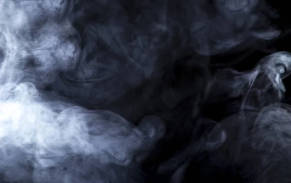 Humo o vapor retroiluminados sobre un fondo negro — Foto de Stock