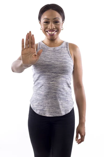 黑人女性穿着运动服装的白色背景作为健身教练做停止手势 — 图库照片