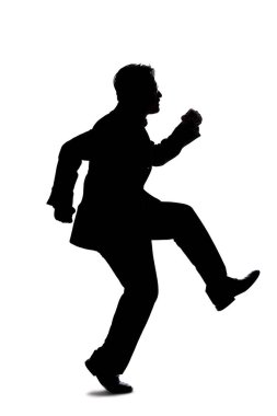 Beyaz arka planda iş adamı kılığına girmiş arka ışıklandırmalı bir modelin silueti. Zıplıyor ya da ileri sıçrıyor..