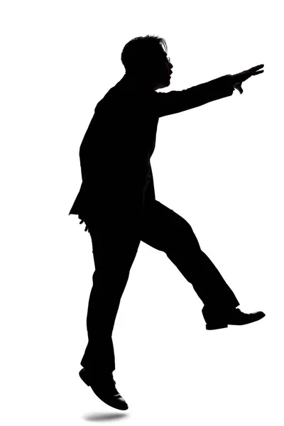 一个背光模特在白色背景下装扮成商人的轮廓 他在跳或向前跳 — 图库照片