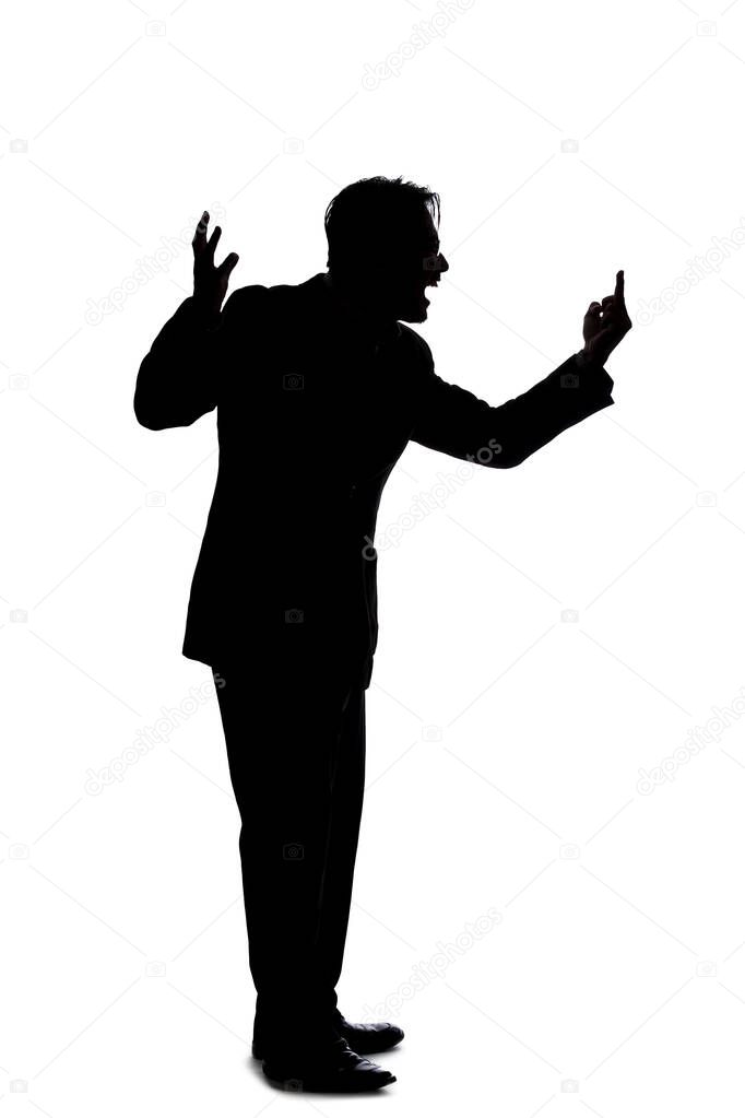 Silhouette of a backlit model posing as a businessman on a white background.  He is shouting in anger and is furious