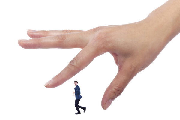 Гигантская женщина держит крошечного бизнесмена в качестве метафоры потери уверенности в себе. Человек чувствует себя уязвимым и беззащитным изолированным на белом фоне
