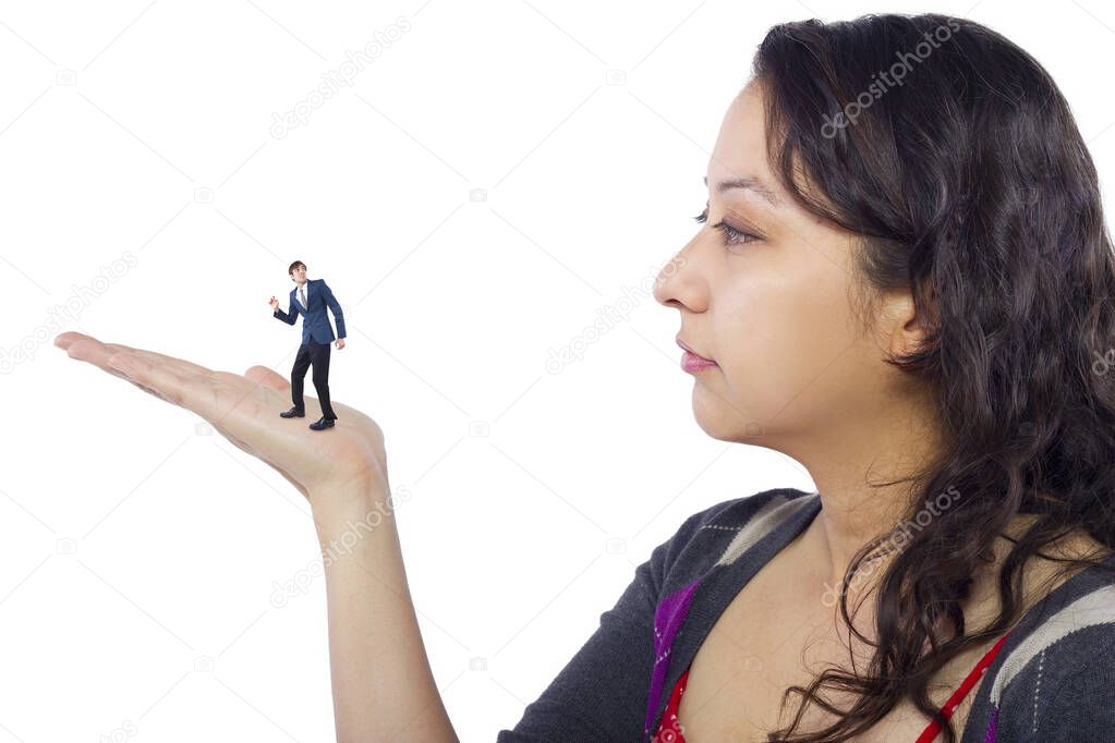 Gigantic woman holding a tiny little businessman as a metaphor for loss of self-confidence.  The man is feeling vulnerable and defenseless isolated on a white background