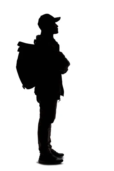 シルエットの男のハイキングや白い背景にバックパックを運ぶ 絶縁されたサイドビューマンは複合材に使用できます 冒険と探検を描く — ストック写真