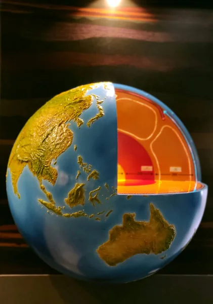 Earth core representation under yellow light with south East Asia and Australia clearly visible