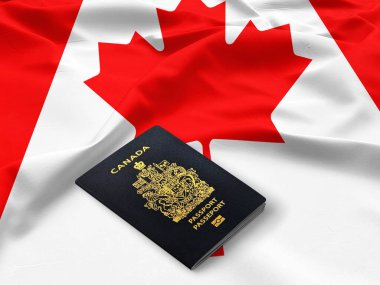 Kanada pasaportu saten bir Kanada bayrağının tepesinde