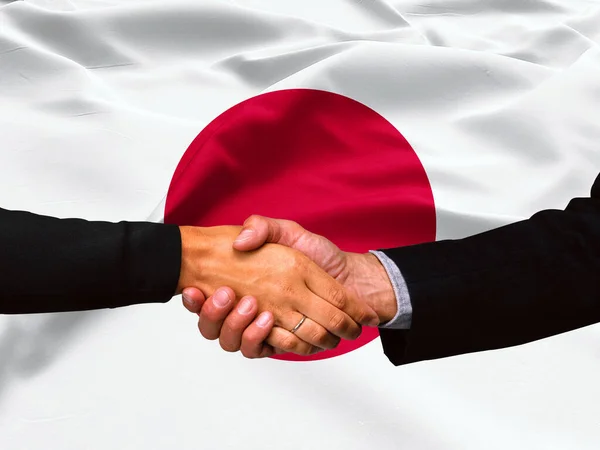 Business handshake on Japan flag background