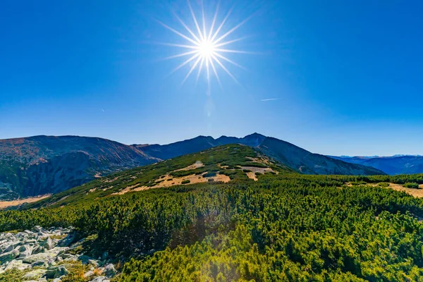 Sun on the blue sky over the mountains overlooking Musala in Rila Region, Bulgaria