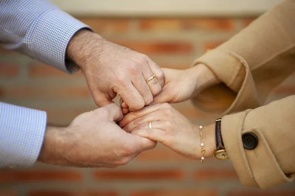 Hands of a couple with rings as a sign of love