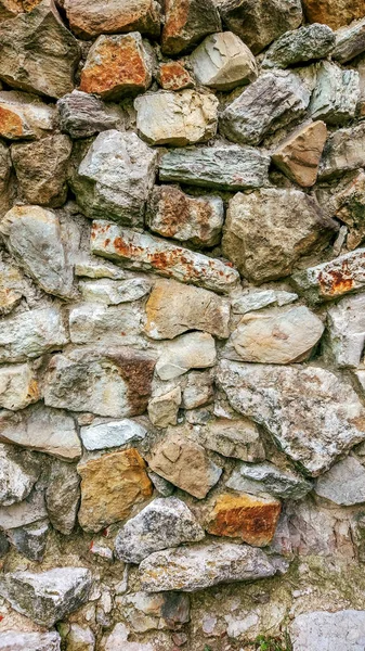 Stone old wall from huge blocks. Background of stones. The concept reliability. The space between stones is filled with cement. Royalty Free Stock Photos