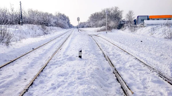 Sleepers from the train, electric train in city in the winter. They are covered with snow from a storm. — Stock Photo, Image
