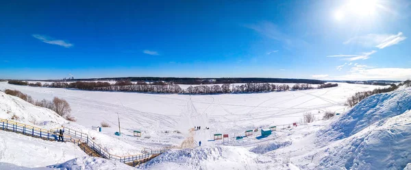 Ponarama pemandangan musim dingin alam. Sungai Oka membeku dan tertutup salju. Di alam di musim dingin di Rusia. Langit biru cerah dengan awan . — Stok Foto