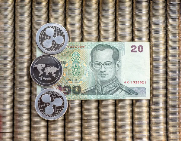 Silver crypto coins Ripple XRP, paper notes Thai baht. Metal coins are laid out in a flat background, close-up view from top, crypto currency exchange of money. — Stock Photo, Image